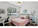 Bedroom offers a study area, a window for natural light, and cozy decor for work and relaxation at 2628 Balforn Tower Way, Winter Garden, FL 34787