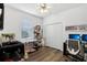 Bright bedroom features a ceiling fan, window, closet and modern wood flooring at 2628 Balforn Tower Way, Winter Garden, FL 34787