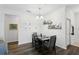 Dining area boasts modern light fixture and decorative shelves with Gathering photos for a personal touch at 2628 Balforn Tower Way, Winter Garden, FL 34787