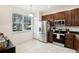 Kitchen features stainless steel appliances, a window for natural light and tile flooring for easy maintenance at 2628 Balforn Tower Way, Winter Garden, FL 34787