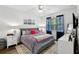 The main bedroom has a ceiling fan, window with privacy blinds and contemporary decor for relaxation at 2628 Balforn Tower Way, Winter Garden, FL 34787