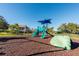 Community playground with slides, climbing structures, and a soft landing surface for neighborhood Gathering fun at 2628 Balforn Tower Way, Winter Garden, FL 34787