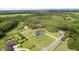A bird's eye view captures a luxury home, with an expansive lawn, complemented by lush surroundings at 27071 Moss View Dr, Tavares, FL 32778
