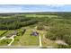 Aerial view of a home with an expansive lawn and perimeter fencing in a lush, green, and wooded area at 27071 Moss View Dr, Tavares, FL 32778