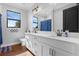 Elegant bathroom featuring a double vanity with views and a shower with blue curtains at 27071 Moss View Dr, Tavares, FL 32778