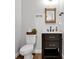Charming bathroom with decorative accents, dark vanity, and rustic mirror at 27071 Moss View Dr, Tavares, FL 32778