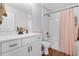 Bright bathroom with white cabinets, quartz countertop, and tub shower combo at 27071 Moss View Dr, Tavares, FL 32778