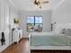 Well-lit bedroom with a large window, light hardwood floors, and study nook at 27071 Moss View Dr, Tavares, FL 32778