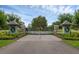 Elegant entrance gate with brick columns and refined landscaping and a secure entryway to the property at 27071 Moss View Dr, Tavares, FL 32778