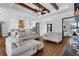 Open-concept living space featuring hardwood floors and a view of the adjacent kitchen and pendant lighting at 27071 Moss View Dr, Tavares, FL 32778