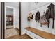 Convenient mud room with a built-in bench, storage, and easy access to laundry and closet at 27071 Moss View Dr, Tavares, FL 32778