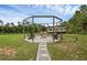 Outdoor pergola with swing seating and gravel base at 27071 Moss View Dr, Tavares, FL 32778