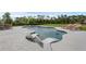 Backyard pool area, complete with chaise lounges, dining table, and serene landscape at 27071 Moss View Dr, Tavares, FL 32778