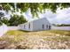 Backyard view of a blue home with white fencing, a grass area, and a sliding glass door at 302 Cello Cir, Winter Springs, FL 32708