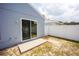 Home backyard view with sliding door, concrete pad, and partial grass coverage at 302 Cello Cir, Winter Springs, FL 32708