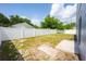Backyard view with partial grass coverage, a concrete patio, and white vinyl fencing at 302 Cello Cir, Winter Springs, FL 32708