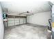 Spacious garage interior featuring white walls, a garage door, and ample storage space at 302 Cello Cir, Winter Springs, FL 32708