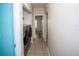 Hallway with laundry closet with stainless steel washer and dryer at 302 Cello Cir, Winter Springs, FL 32708