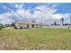 Spacious backyard with ample green space, a patio, and white fencing for privacy and relaxation at 3043 Mapleshade St, Deltona, FL 32738