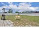 Well-maintained, fenced backyard featuring a small patio and a dining set perfect for outdoor enjoyment at 3043 Mapleshade St, Deltona, FL 32738