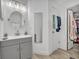 Bathroom boasts modern vanity, sleek mirror, and a closet with ample storage at 3043 Mapleshade St, Deltona, FL 32738