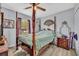 Cozy bedroom featuring a distinctive four-poster bed, ceiling fan and natural light from the window at 3043 Mapleshade St, Deltona, FL 32738