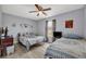 Cozy bedroom features two beds, neutral walls, and light-colored flooring at 3043 Mapleshade St, Deltona, FL 32738