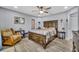 Cozy bedroom with decorative ceiling fan, wood furnishings, and neutral color palette at 3043 Mapleshade St, Deltona, FL 32738