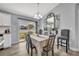 Bright dining room with large windows, neutral tones, and backyard views at 3043 Mapleshade St, Deltona, FL 32738