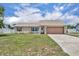 Charming single-story home featuring a well-maintained lawn and an attached two-car garage at 3043 Mapleshade St, Deltona, FL 32738