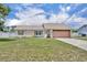 Charming single-story home featuring a well-maintained lawn and an attached two-car garage at 3043 Mapleshade St, Deltona, FL 32738