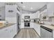 Spacious kitchen featuring white cabinets, stainless steel appliances, and stone countertops at 3043 Mapleshade St, Deltona, FL 32738