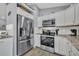 Modern kitchen with stainless steel refrigerator and complementing appliances at 3043 Mapleshade St, Deltona, FL 32738