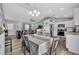 Open concept kitchen and dining area featuring white cabinets and stainless steel appliances at 3043 Mapleshade St, Deltona, FL 32738
