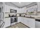Well-equipped kitchen features stainless steel appliances, white cabinets, and plenty of countertop space at 3043 Mapleshade St, Deltona, FL 32738