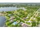 Stunning aerial view of a home nestled near a serene lake, surrounded by lush trees and well-manicured lawns at 3102 Cecelia Dr, Apopka, FL 32703