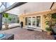 Covered back patio, brick pavers, ceiling fan, outdoor lights, with pool in background at 3102 Cecelia Dr, Apopka, FL 32703