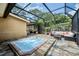 Outdoor hot tub, furniture, stone tile, and the screened-in pool are ready for entertaining at 3102 Cecelia Dr, Apopka, FL 32703