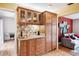 Charming bar area with custom wood cabinets, granite countertops, and stylish tile backsplash at 3102 Cecelia Dr, Apopka, FL 32703