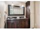 Bathroom featuring dual sinks with granite countertops and dark wood cabinets at 3102 Cecelia Dr, Apopka, FL 32703