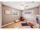 Bright bedroom featuring a ceiling fan, hardwood floors, and a yoga mat for a peaceful workout space at 3102 Cecelia Dr, Apopka, FL 32703