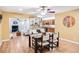 Open dining room with wood floors, a ceiling fan and easy access to the kitchen and living area at 3102 Cecelia Dr, Apopka, FL 32703