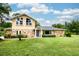 Charming two-story home with stone accents, beautiful landscaping, and a well-maintained lawn at 3102 Cecelia Dr, Apopka, FL 32703