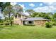 Charming two-story home with stone accents, beautiful landscaping, and a well-maintained lawn at 3102 Cecelia Dr, Apopka, FL 32703