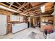 Unfinished garage space with exposed beams, workbench, and storage cabinets at 3102 Cecelia Dr, Apopka, FL 32703