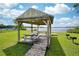 Lakeside gazebo with picnic tables and BBQ grills at 3102 Cecelia Dr, Apopka, FL 32703