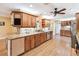 Spacious kitchen featuring beautiful wood cabinets, granite countertops, and stainless steel appliances at 3102 Cecelia Dr, Apopka, FL 32703