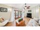 Bright living room featuring wood floors, a ceiling fan and sliding glass doors to the patio at 3102 Cecelia Dr, Apopka, FL 32703