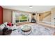 Bright living room featuring a large window with backyard views and easy access to the foyer at 3102 Cecelia Dr, Apopka, FL 32703