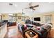 Vaulted ceiling and large windows let natural light into this living room with hardwood flooring and ample seating at 3102 Cecelia Dr, Apopka, FL 32703
